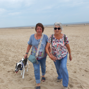 Petra (left) and Maureen (right) walking the dog on the beach. 