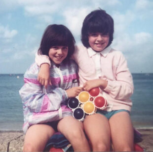 Zoe (left) and Nina (right) on the beach as children